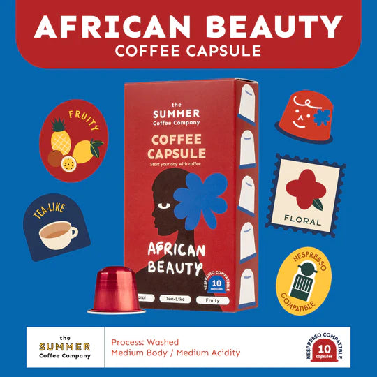Front angled view of The Summer Coffee Company African Beauty coffee capsule box with a red capsule, highlighting Nespresso compatibility.