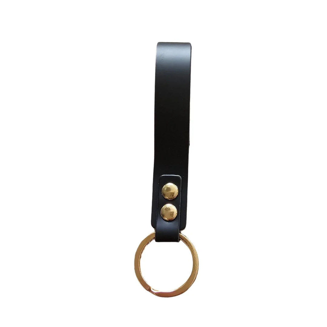 Front view of a LYDY black leather loop keychain with gold-toned rivets and a gold split ring, shown on a white background.